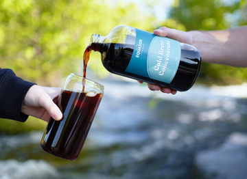 A person pouring our cold brew concentrate into a glass.