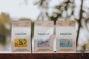 Three bags of coffee beside each other.