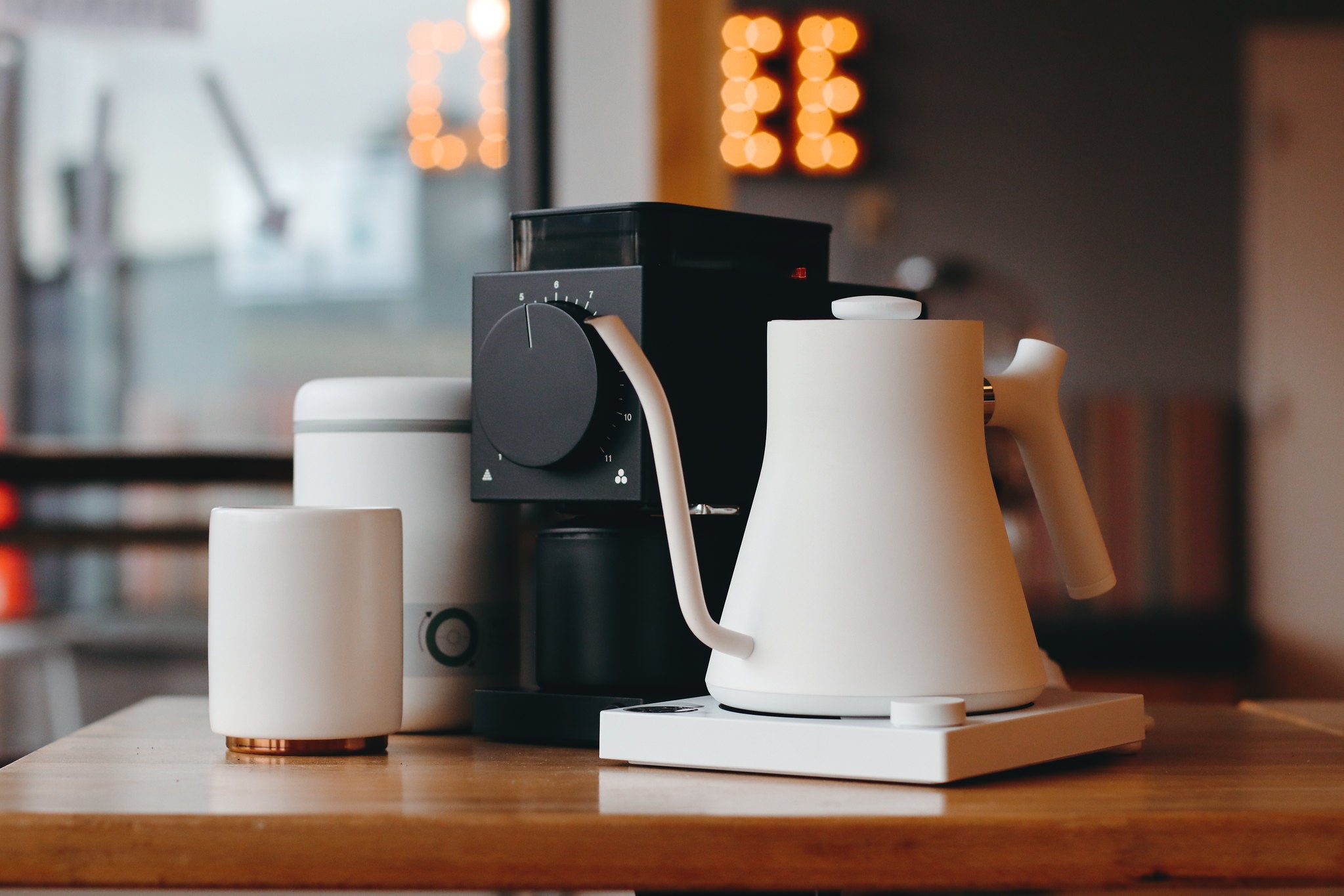 A line of Fellow products. A canister, Ode grinder and an electric kettle.