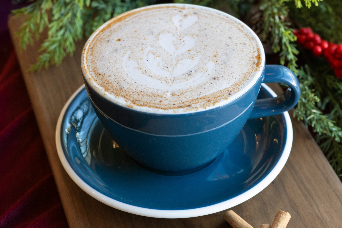 Eggnog chai latte in a blue mug.