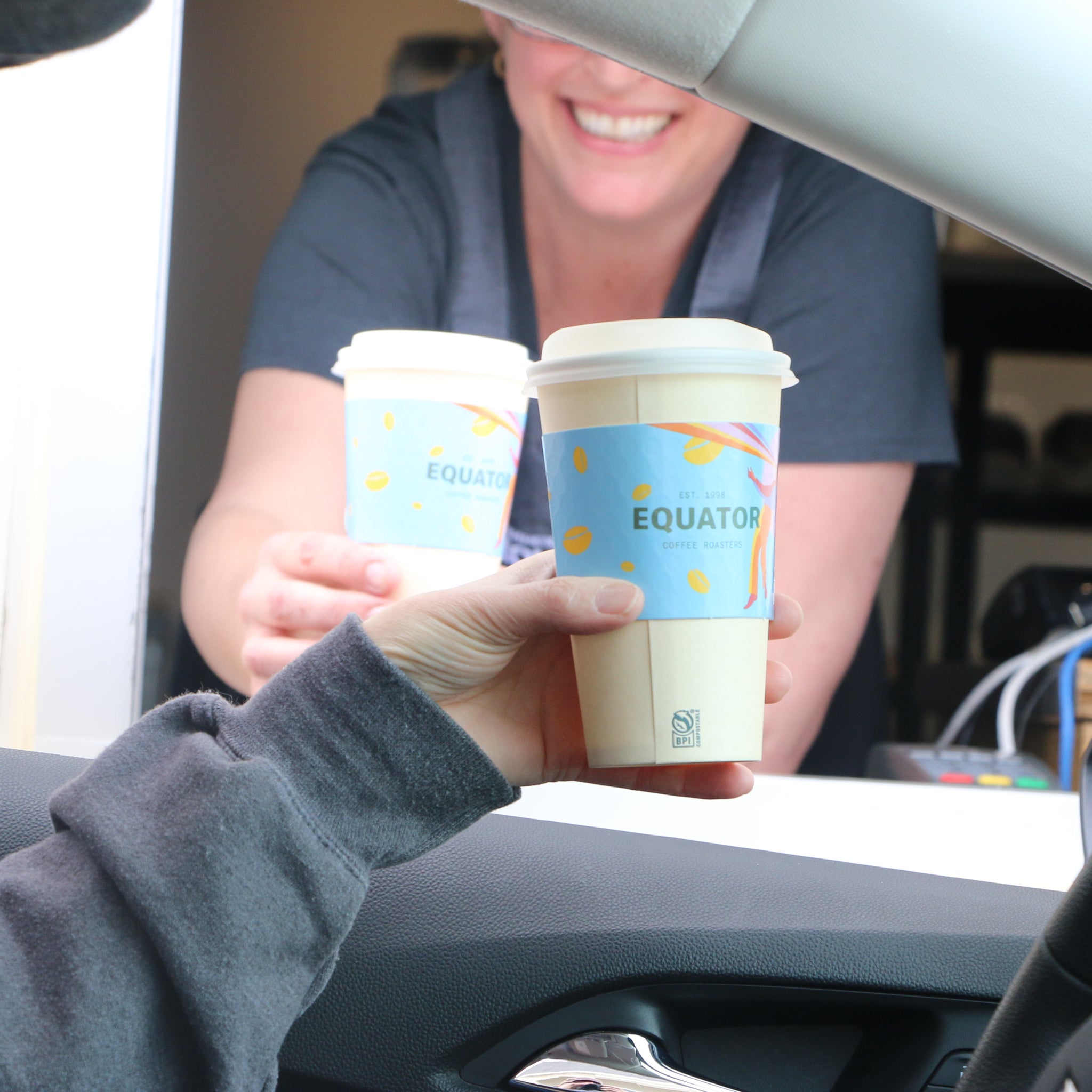 Christena receiving a coffee from Jodie in our drive thru at our Almonte cafe.