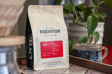 Bag of Mexico Chiapas on a tray with a cup of coffee beside it