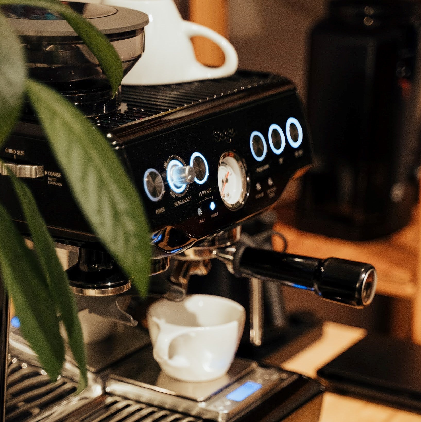 An espresso machine with a mug on it.