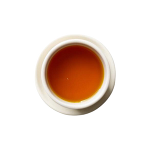 Cup of steeped turmeric ginger tea.