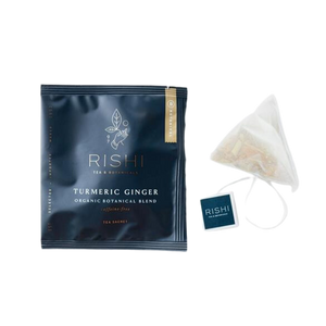Package of Rishi organic turmeric ginger tea and tea bag.