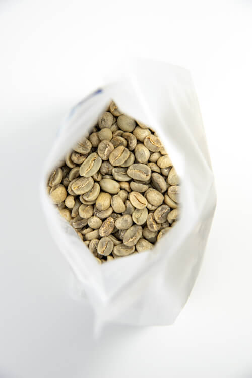 
                  
                  Load image into Gallery viewer, Looking into the bag of green coffee beans
                  
                  