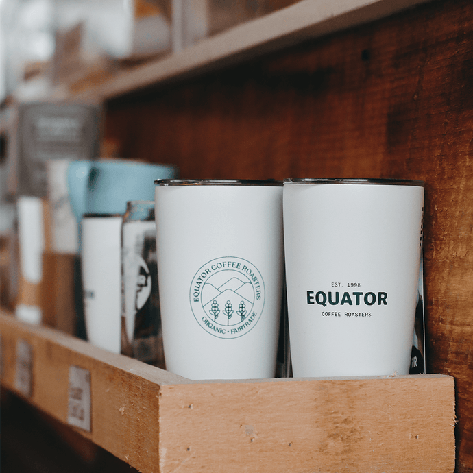 Two 12 oz Miir tumblers showing the front and back logos from Equator Coffee Roasters Inc.