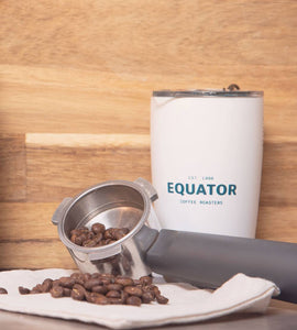 Coffee beans and the Equator 12 oz Miir tumbler.